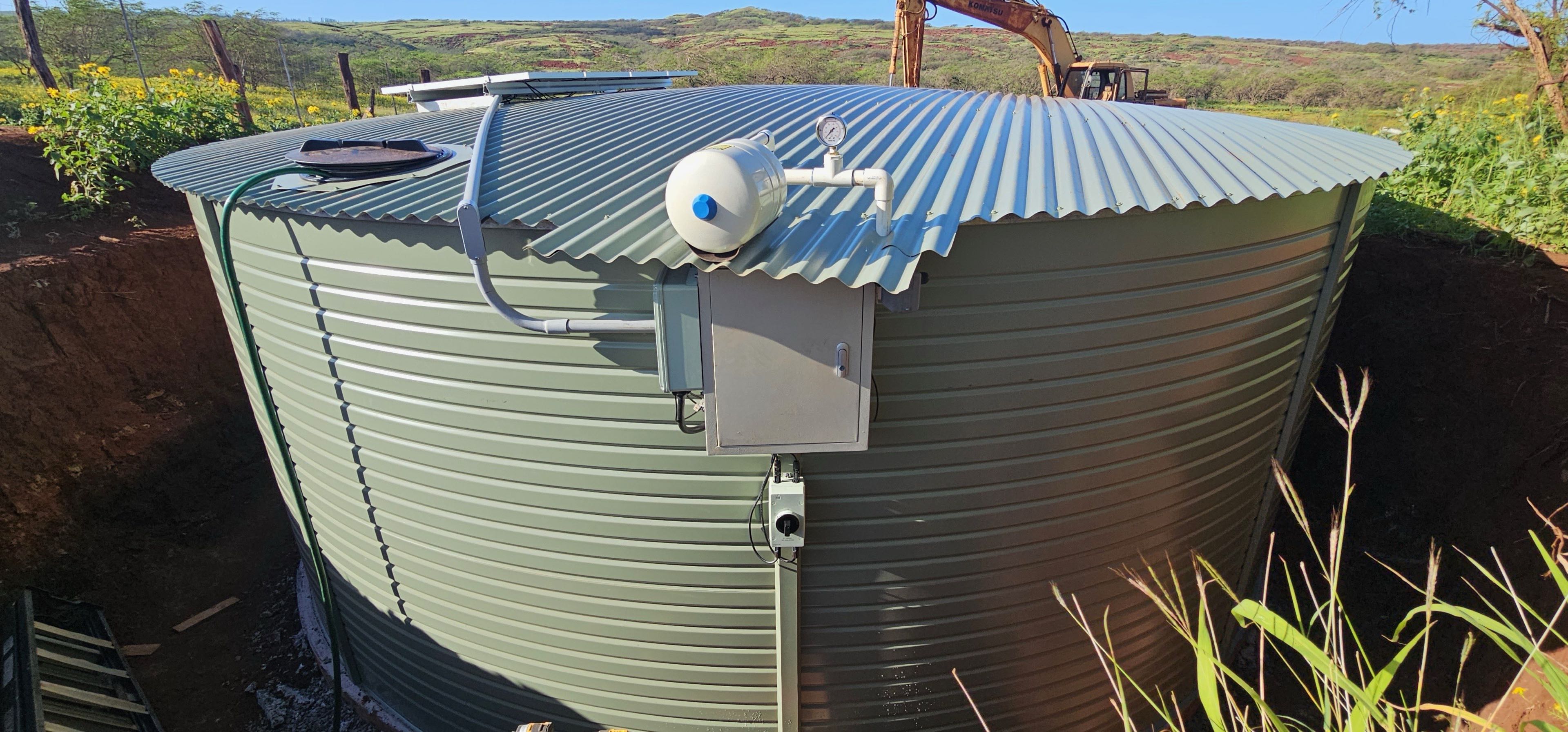 Pioneer water tank closeup showing pressure tank and plumbing connections Hawaii